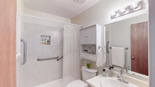 A white toilet sits next to a sink in a small bathroom.