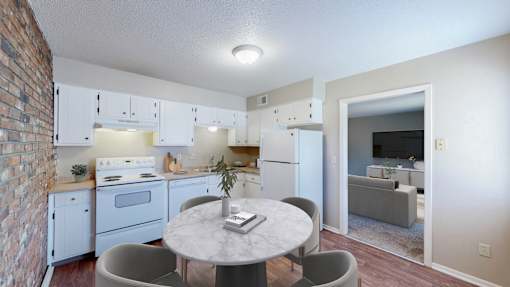 A kitchen with a table and chairs in front of it.