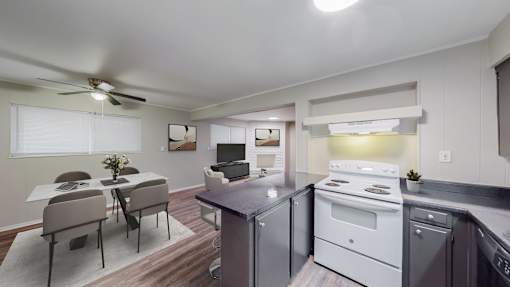 A modern kitchen with a dining table and chairs.