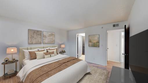 A bedroom with a large bed and two lamps on side tables.