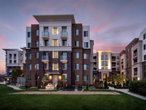 A modern apartment building with a well-maintained lawn in front. at West Park Apartments, San Diego, 92108