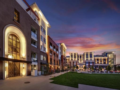 A modern building with a well-lit courtyard in the foreground at West Park Apartments, San Diego, CA, 92108