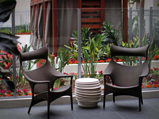 Two chairs and a table are on a patio at West Park Apartments, San Diego
