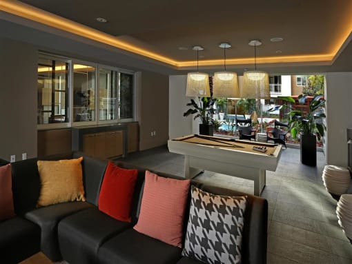 A living room with a black couch and a coffee table at West Park Apartments, California, 92108