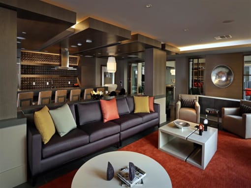 A modern living room with a dark brown couch and a white coffee table at West Park Apartments, San Diego, CA, 92108