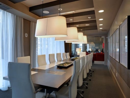 A conference room with a long table and chairs at West Park Apartments, San Diego, 92108