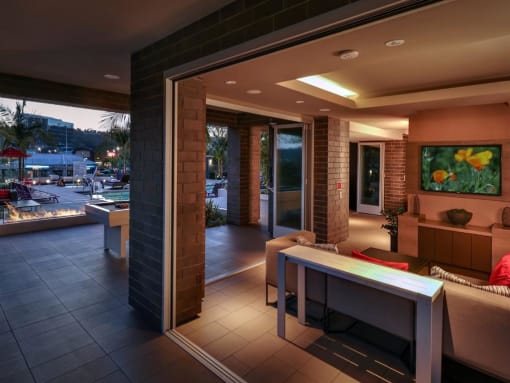 A modern living room with a fireplace and a view of the outdoorsA modern living room with a fireplace and a view of the outdoors. at West Park Apartments, San Diego, CA, 92108