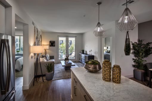 A kitchen with a marble countertop and pendant lights at Purl Apartments, San Diego, CA, 92108