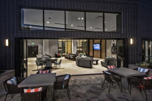 A patio with a table and chairs is set up outside a building at Purl Apartments, San Diego, California