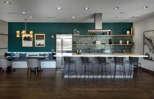 A modern kitchen with a bar area and dining table at Circa 37 Apartments, San Diego, 92108