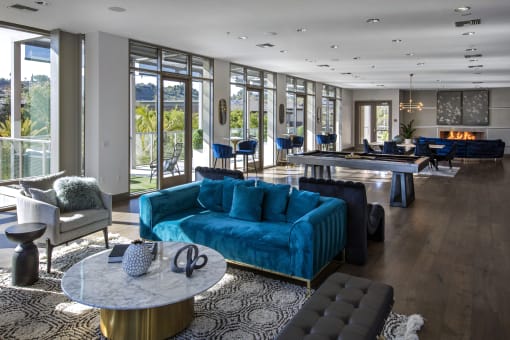 A living room with a blue couch and a fireplace at Circa 37 Apartments, San Diego, CA