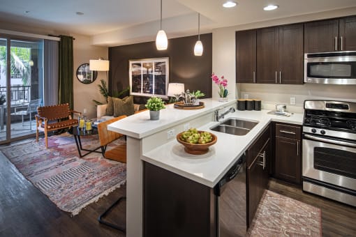 A modern kitchen with a large island and stainless steel appliances at Circa 37 Apartments, California
