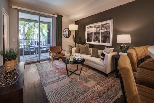 A living room with a sofa, armchairs, and a coffee table at Circa 37 Apartments, San Diego
