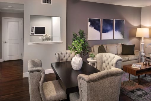 A modern dining room with a dark table and chairs at Circa 37 Apartments, California