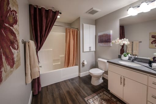 A bathroom with a toilet, sink, and bathtub at Circa 37 Apartments, San Diego, 92108