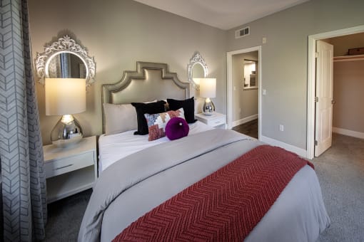 A bedroom with a large bed and two lamps at Circa 37 Apartments, San Diego, CA, 92108
