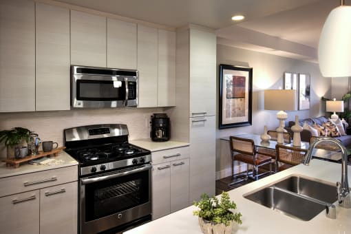 A modern kitchen with a stainless steel oven and microwave. at West Park Apartments, San Diego, California
