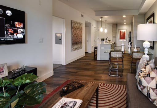 A living room with a couch, a coffee table, and a television. at West Park Apartments, San Diego, CA, 92108