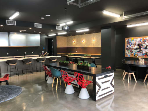 A modern dining area with a long table and chairs at Purl Apartments, San Diego, 92108