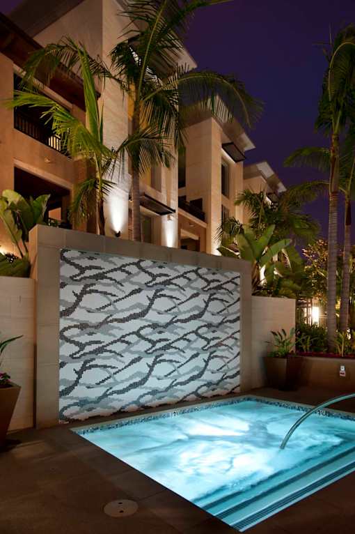 A pool with a light blue tinted water and a wall with a tree pattern at Circa 37 Apartments, San Diego, CA, 92108