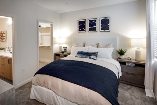 a bedroom with a bed and a bathroom at Luma at El Corazon Apartments, California 92056
