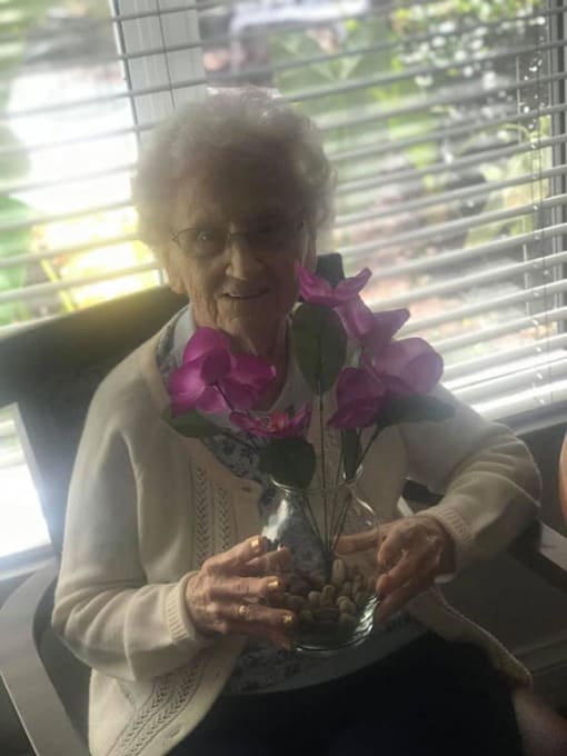 Senior Resident With Flowerpot at Savannah Court of Brandon, Brandon, Florida