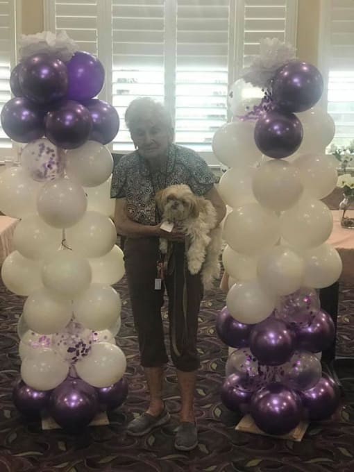 Senior Carrying A Dog at Savannah Court of Brandon, Brandon, 33510