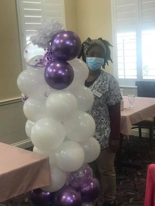 Team Member With Balloon at Savannah Court of Brandon, Brandon, FL