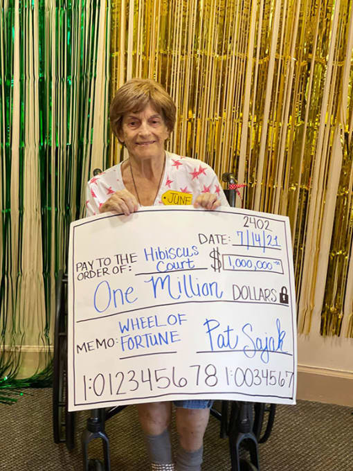 Lady Poses With A Cheque at Hibiscus Court, Melbourne, 32901