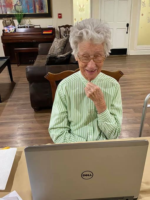 Senior Resident In-front Of Laptop at Savannah Court of Brandon, Brandon, Florida