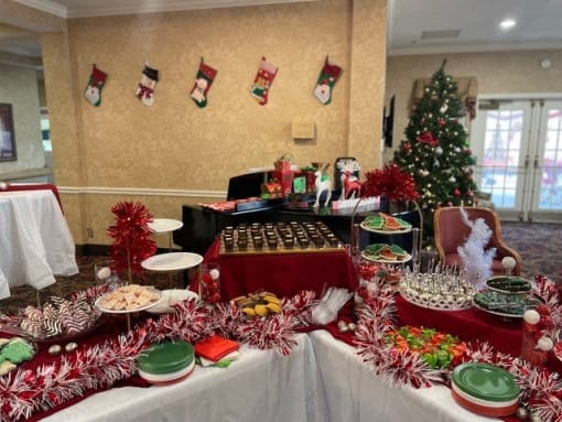 a christmas buffet table with a tree in the background