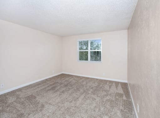 an office with a desk and a chair and a window