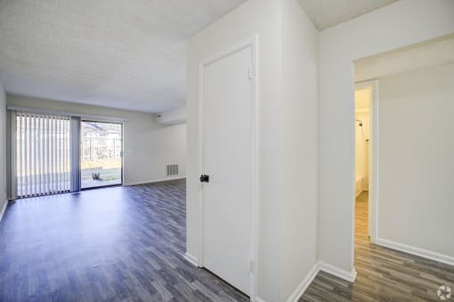 the spacious living room and dining room of an apartment