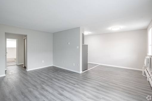 A room with a grey floor and white walls.