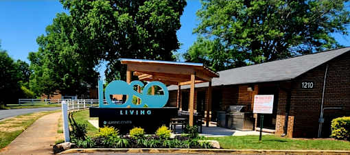 A building with a sign that says "LOVE LIVING" in front of it.