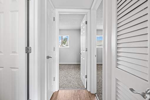 A white door is open to a hallway.