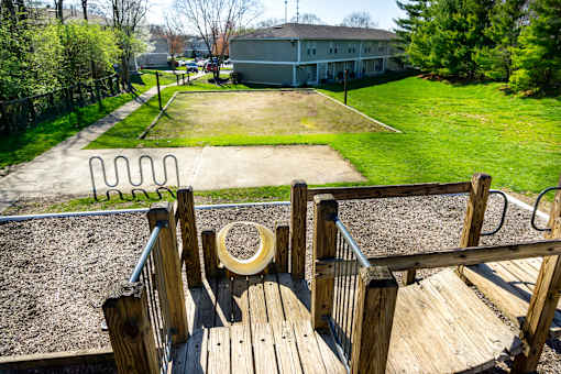 A playground with a wooden structure and a slide.