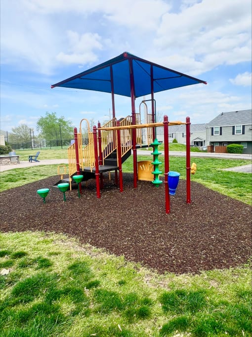 a playground with a swing set in a park