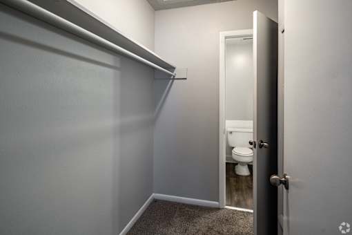 A white bathroom with a toilet and a door.