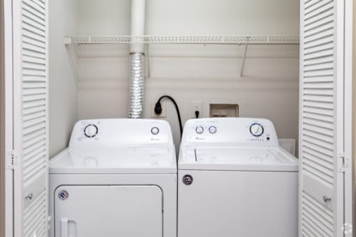 a laundry room with two washes and a dryer