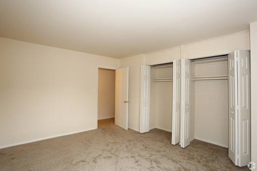 A room with a carpeted floor and white walls.