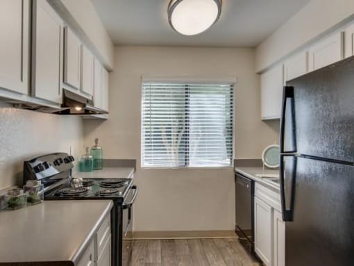 a kitchen with stainless steel appliances and white cabinets