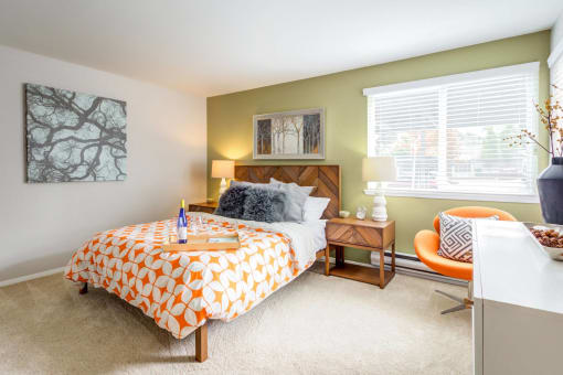 a bedroom with a bed and a desk and a window