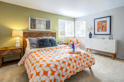 a bedroom with a bed and two windows
