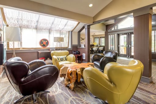 a living room with leather chairs and a table