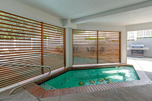 a spa with a pool and sliding glass doors