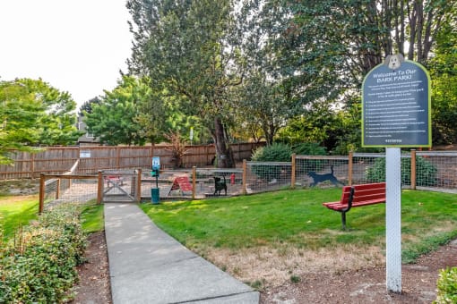 a park with a sign for a dog park