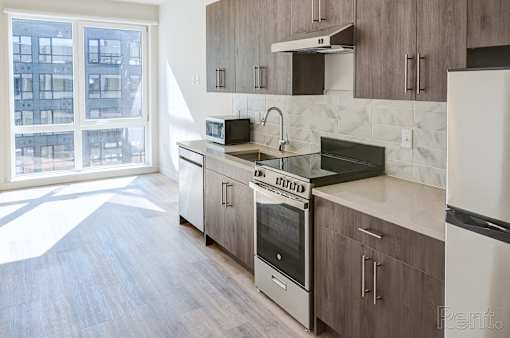 A kitchen with a stove top oven and a microwave.