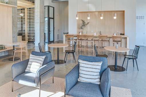 A room with a long table and chairs.