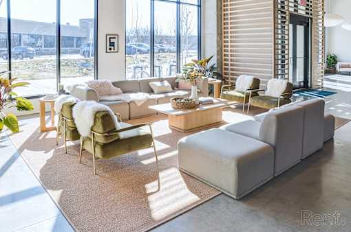 A living room with a couch, chair, and table.